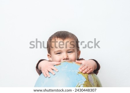 Child with his hands on a globe. Future. Planet. Copy space