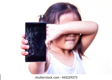 child with holding broken touch screen mobile phone