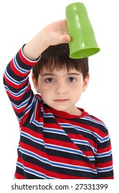 Child Holding Empty Cup Upside Down With Disappointed Expression.