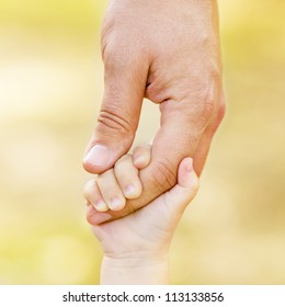 Child holding father's hand