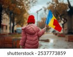 

Child Holding a Flag Celebrating Great Union Day in Romania. Romanian girl celebrating the national day on December 1st
