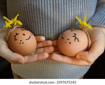 child holding funny easter eggs, close-up, yellow, flowers, forsythia, family, tradition, holiday, postcard, congratulations, feelings, white, yellow, orange, tenderness.
