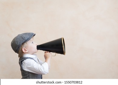 Child Holding Loudspeaker. Kid Shouting Through Vintage Megaphone. Business News Concept