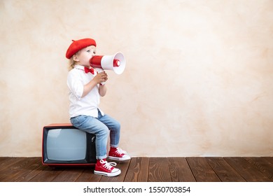 Child Holding Loudspeaker. Kid Shouting Through Vintage Megaphone. Business News Concept