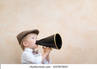 Child Holding Loudspeaker. Kid Shouting Through Vintage Megaphone. Business News Concept