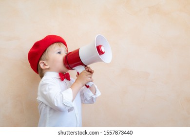 Child Holding Loudspeaker. Kid Shouting Through Vintage Megaphone. Business News Concept