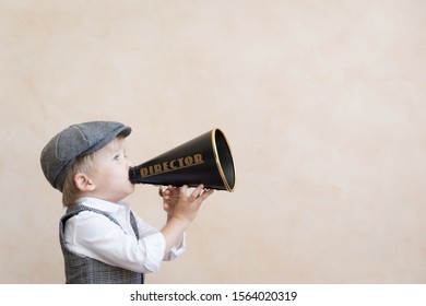 Child Holding Loudspeaker. Kid Shouting Through Vintage Megaphone. Business News Concept