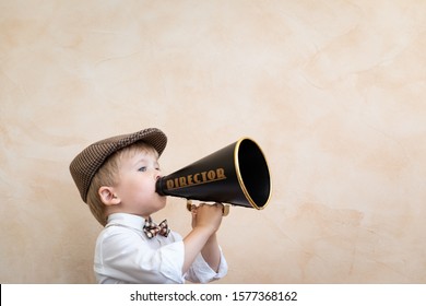 Child Holding Loudspeaker. Kid Shouting Through Vintage Megaphone. Business News Concept