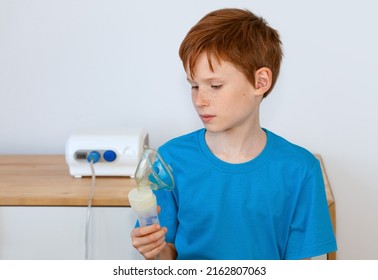 The Child Is Holding A Nebulizer For Inhalation. Cough Treatment Concept, Covid19