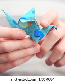 Child Holding Origami Crane Close Up