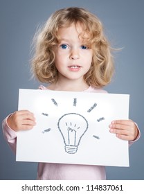 Child Holding Paper With Hand Drawn Bulb. Idea Concept