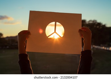 Child Holding Up Peace Symbol Sign 