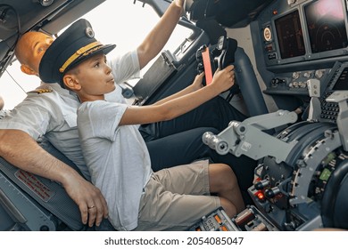 Child Holding The Steering Wheel In The Cockpit. Aircraft Concept