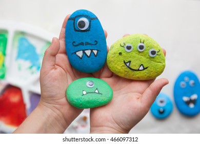 Child Holding Stone Monster Family Craft