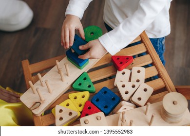 Child Holds Educational Toys. Close Up. Top View.