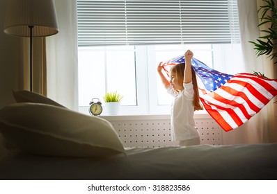 Child Holds A Flag Of America