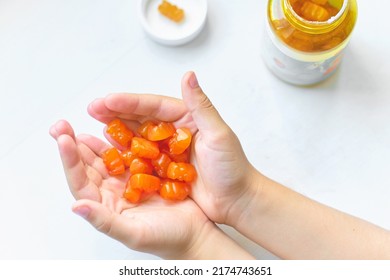 Child Holds A Handful Of Vitamins For Children In The Palms. Vitamin Overdose, Synthetic Vitamins