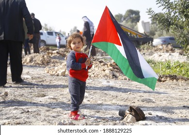 A child holds a Palestinian flag. Qalqilya, Palestinian Territories, Palestine, January 6,2021