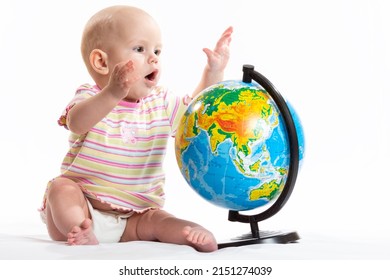 The Child Holds The Planet Earth In His Hands. War In Ukraine. Russia Terrorist. Stop War. Toy Globe In Children's Hands. Peace On Earth Concept