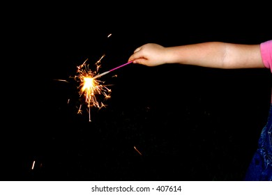 A child holds a sparkler to celebrate the America's Fourth of July