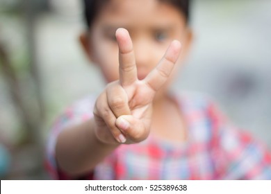 Child Holds Two Fingers Up