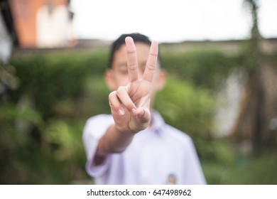 Child Holds Two Fingers Up