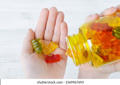 Child Holds Vitamins For Kids Like Jelly Candy