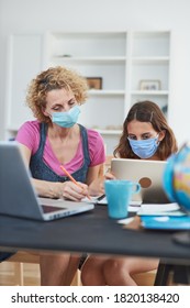 Child Home Studying Education, Homeschooling, With Private Tutor / Mother With Protective Mask In The Time Of Viruses, Flu And Seasonal Pandemic.