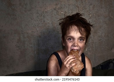 Child Homeless, Beggar Eats A Piece Of Black Bread (concept Of War, Poverty, Crisis)