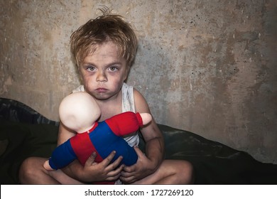 Child Homeless, Beggar Holds An Old, Destroyed Toy (concept Of War, Poverty, Crisis)