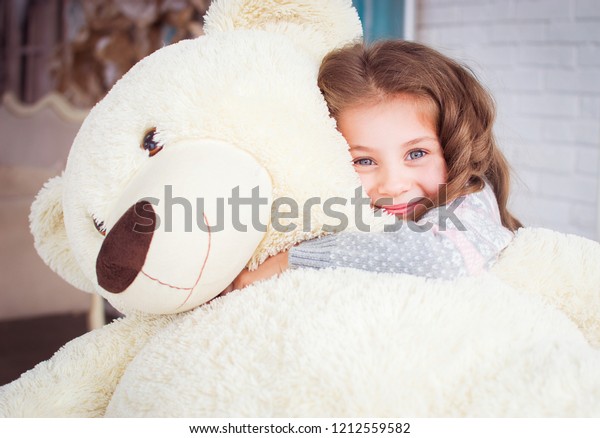 hugging big teddy bear