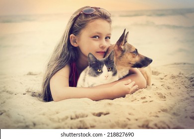 Child Hugging A Cat And Dog