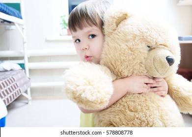 Child Hugging Teddy Bear Indoor In Her Room, Devotion Concept,big Bear Toy