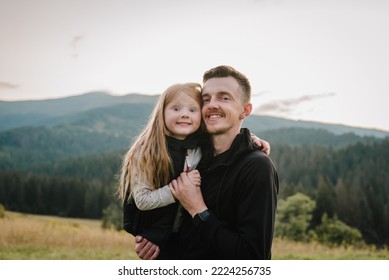 Child Hugs Father. Dad And Daughter Walk In The Mountains Enjoy Autumn And Look At Nature.  The Young Family Spends Time Together On Vacation, Outdoors. Father's Day. Closeup. Happy And Funny Face.