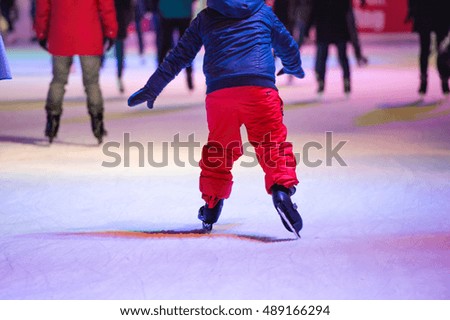Child ice skating at night in Vienna, Austria. Winter.