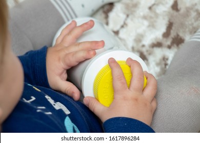 A Child Independently Tries To Open A Plastic Bottle Of Medicine, Close-up. Child-resistant, Childproof Or CR Packaging. Push&Turn Cap. Child Safety Concept