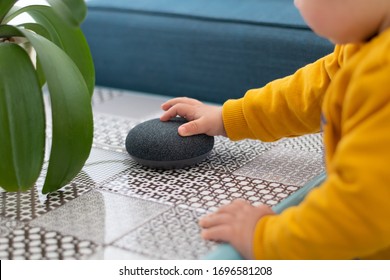 Child Interacting With Smart Home Assistant Speaker