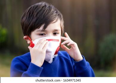 Child Itchy Eyes And Nose, Kid Scratching Nose While Wearing Protection Mask, Kid Has Reflection Or Hay Fever During Season Change.A Boy Wearing Medical Face Mask For Pollution Or Virus