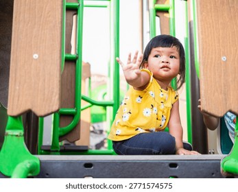 A child joyfully explores playground capturing innocence of childhood in a bright outdoor setting.