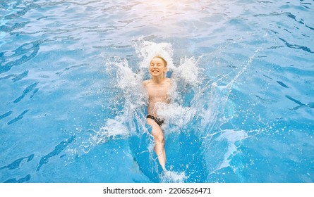 Child Jump, Swim In The Pool, Sunbathes, Swimming In Hot Summer Day. Relax, Travel, Holidays, Freedom Concept. 4K Slow Motion