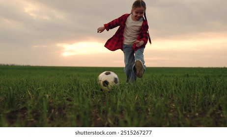 child kid baby girl run across green lawn sunset, kicking soccer ball, playing football field, childhood dream happy kid, outdoor soccer hobby, casual soccer play, sunny day football, community soccer - Powered by Shutterstock