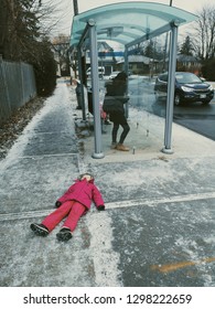 Child Kid In Tantrum Bad Mood Lying On Ground In City Outside Street Not Willing To Obey Parents. Parenting Problems And Challenges. 