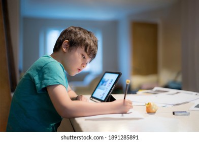 Child kid using tablet for homework at home,Student study research information online internet,Education Ai Technology,Asian Young Boy Concentration read and writing on notepad book,Preschool lesson - Powered by Shutterstock