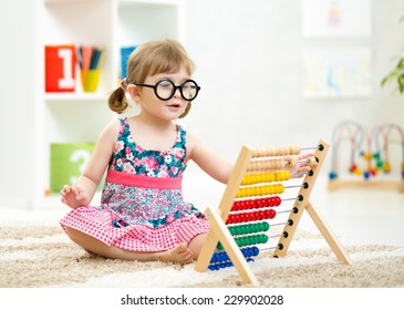 Child Kid Weared Glasses Playing With Abacus Toy Indoor