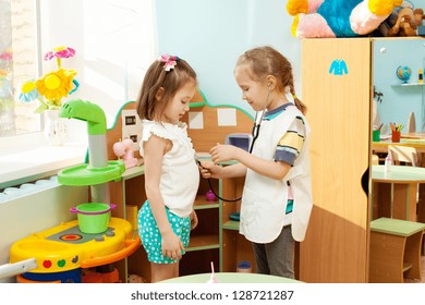 Child in kindergarten. Kids in nursery school. Girl playing at infant school