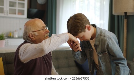 A child kissing his grandfather's hands during the feast (Ramadan or Şeker Bayram). People who adhere to Muslim traditions. The child kisses his grandfather's hand, celebrates Eid or Father's Day, - Powered by Shutterstock