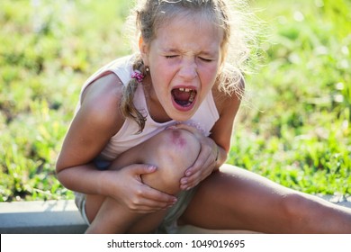 Child Knee Injury. Crying Girl