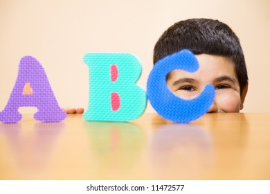child learning the ABC's. The focus is on the his eyes