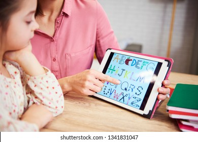 Child Learning The Alphabet On The Tablet
