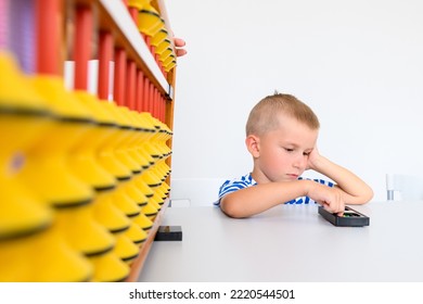 Child with learning difficulty in occupational therapy. A boy doing playful exercises during math tutoring session.